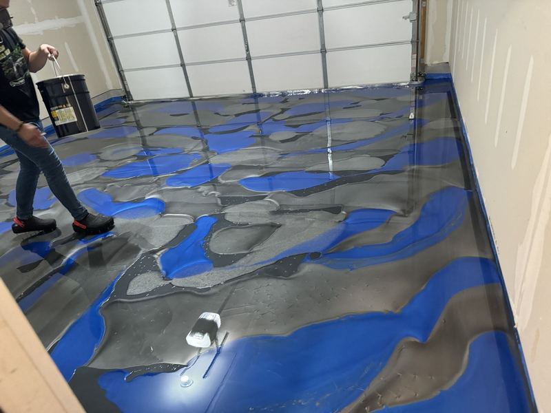 Bands of blue, gray and silver metallic epoxy poured on a garage floor in Joliet, IL