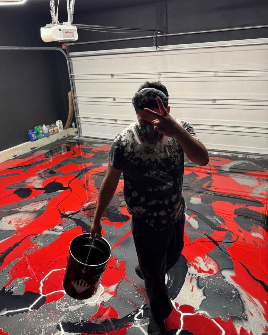Red, black and white metallic epoxy being poured on a garage floor in Joliet, IL
